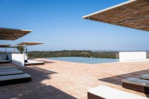 a patio with a view of the water at Herdade do Carregouçal in Odemira