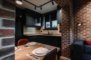 a kitchen with a table and a brick wall at Karma Chic&Style Intera Villa in Korçë +159 photos