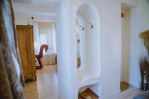 a white door in a room with a mirror at Old Believers Apartment in Rēzekne