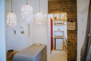 a kitchen with a metal refrigerator and pendant lights at Old Believers Apartment in Rēzekne