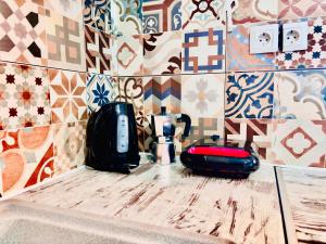 a kitchen counter with a coffee maker and a blender at Anemeli 2-bedroom apartment, Stoupa in Stoupa +31 photos