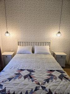a bedroom with a bed with two night stands and two lights at Borsk Sielanka in Borsk +28 photos