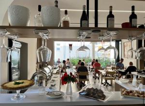 a restaurant with people sitting at tables in a room at Seaside Hotel in Vlorë
