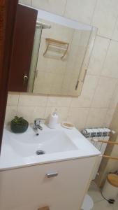a bathroom with a sink and a mirror at Moradia Vinhais in Vinhais