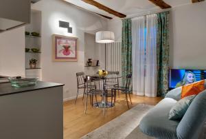 a living room with a blue couch and a table at Piazza Vittorio Suites in Turin