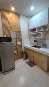 a kitchen with a sink and a refrigerator at Cozy Home in Dadiangas, General Santos City - Perfect for Families 