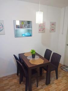a dining room table with chairs and a potted plant on it at Cozy Home in Dadiangas, General Santos City - Perfect for Families 