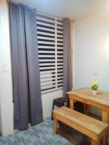 a room with a wooden table and a window at Cozy Home in Dadiangas, General Santos City - Perfect for Families  +2 photos