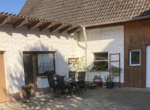 a patio with a table and chairs in front of a building at FeWo-Viktoria in Rheinau