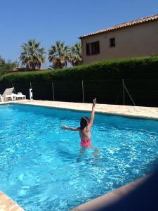 a woman is standing in a swimming pool at Toi & Moi in Sainte-Maxime