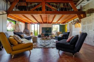 a large living room with couches and a tv at Karibu Lodge Boutique in Vega de San Mateo