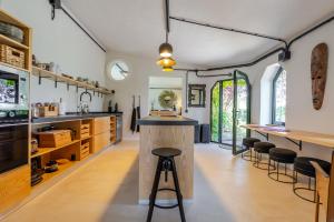 a kitchen with a counter and stools in a room at Karibu Lodge Boutique in Vega de San Mateo