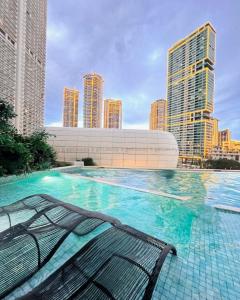 a swimming pool with a view of a city at Acqua at The Hotel Residences Acqua Manila near Makati and BGC in Manila