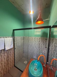 a bathroom with a blue sink and a shower at Casa natureza in Paraty +25 photos