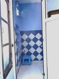 a small bathroom with a blue and white tiled wall at Dar Besmellah in Chefchaouen +59 photos