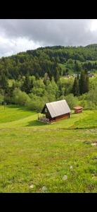 un granero en medio de un campo de hierba en Mountain House Jelovica, en Berane 6 fotos más