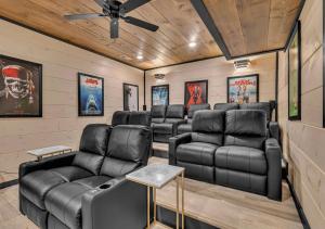 a movie room with leather furniture and a ceiling fan at Homestead Bluff in Sevierville