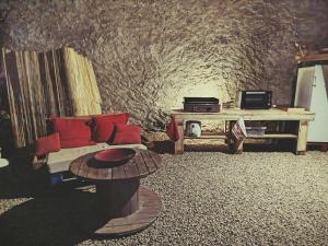 a living room with a couch and a table at Parenthèse Aiyanna in Moux-en-Morvan