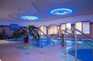 a swimming pool in a building with blue lights at Bornemisza Kuria in Tiszabecs