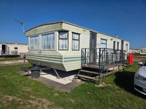 a mobile home is parked in a yard at Beckys Holiday Van in Ingoldmells
