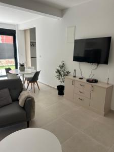 a living room with a couch and a flat screen tv at Villa Richard in Sutomore