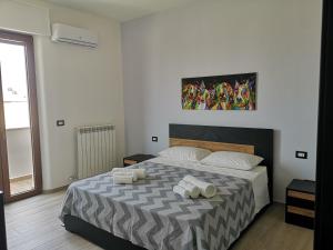 a bedroom with a bed with two towels on it at B&B Scirocco e Tramontana in Gallipoli