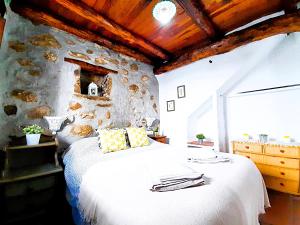 A bed or beds in a room at Petit Nazari