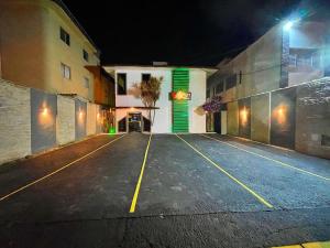 an empty parking lot in front of a building at night at Pousada Vison Ubatuba - Praia Grande in Ubatuba +24 photos