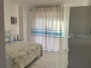 a bedroom with a bed and a window at Sweet Home Pia in La Maddalena