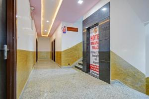 a corridor in a building with a sign on the wall at Capital O Maharana Palace in Udaipur +19 photos
