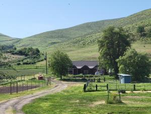 a farm with a barn and a dirt road at 8 Mile Farm Bed & Breakfast in The Dalles