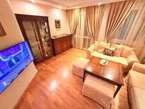 a living room with a couch and a table at На 2 мин от плажа!Victoria- две спални делукс до Морската градина и центъра in Burgas +43 photos