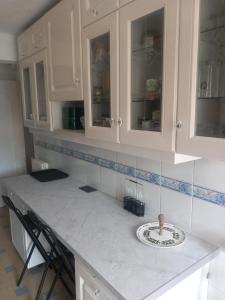 a kitchen with white cabinets and a plate on a counter at Chambre B2 dans un appartement en colocation in Marseille