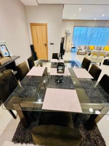 a conference room with a glass table and chairs at Villa Bahia Golf beach - Bouznika in Casablanca +59 photos