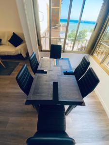 a table and chairs in a room with a view of the ocean at Seaview Apartman Santa Pola in Santa Pola +5 photos