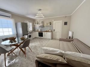a kitchen and living room with a couch and a table at Casa Limone in Argostoli