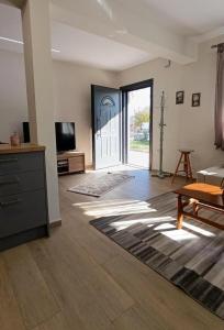 a living room with a tv and a couch and a table at Cozy Bungalow in Tríkala