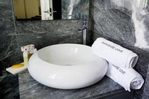 a bathroom with a sink and towels on a counter at Luxury Cyprus Villa Indigo Villa Private Pool Sea View 1 Bdr Paphos in Paphos