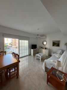 a bedroom with a bed and a table and a dining room at Bacarola in Los Mártires