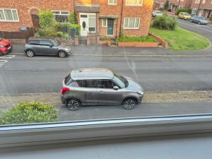 a small car parked on a city street at 2 double bedroom house 20mins walk to Durham city centre in Gilesgate +6 photos