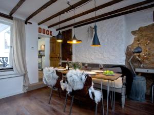 a dining room with a table and chairs with fur at Fishlegs in Brixham