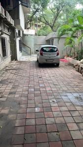 a car parked in a parking lot next to a building at Glitz T2 Grand-Next to Intl Airport in Mumbai