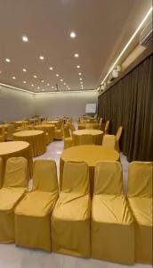 a conference room with yellow tables and chairs at Glitz T2 Grand-Next to Intl Airport in Mumbai +16 photos