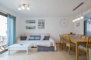 a living room with a bed and a dining table at Lightbooking Costa Antigua Fuerteventura in Costa de Antigua