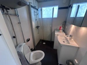 a small bathroom with a toilet and a sink at Guest house in Trollbäcken in Tyresö
