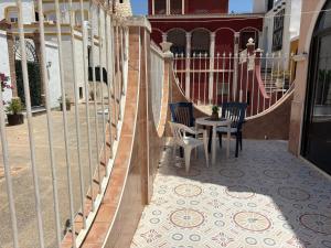 a balcony with two chairs and a table on a building at Ideal pool Bungalow HMWY in Torrevieja