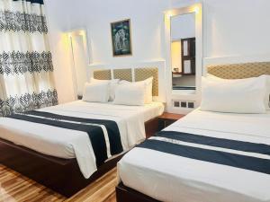 Postel nebo postele na pokoji v ubytování Grand Residence