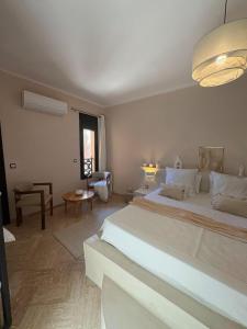 a bedroom with a large white bed in a room at Riad Perles d'Annellia in Marrakech