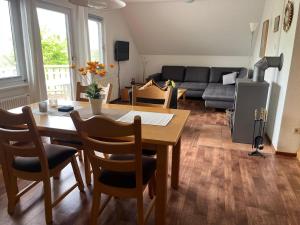 un salon avec une table et un canapé dans l'établissement Haus Waldzeit, inclusief bedlinnen handdoeken en eindservice, à Frankenau