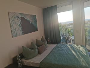 a bedroom with a bed and a large window at Fewo Ostseeparadies Meerblick in Graal-Müritz